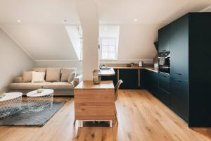 a living room with a couch and a table at NEU! 100 qm Apartment im Zentrum von Dresden in Dresden