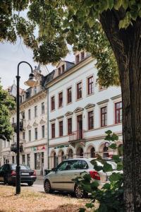 a street with cars parked in front of a building at NEU! 100 qm Apartment im Zentrum von Dresden in Dresden