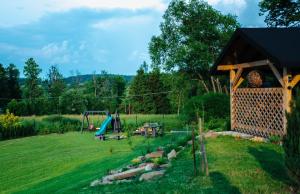 a backyard with a playground and a play structure at Bieszczadzka Miejscówka in Lutowiska