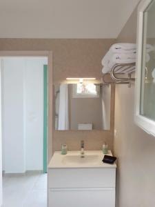 a bathroom with a sink and a mirror at Phileo Villas in Platithriás