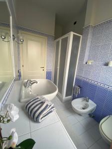 a blue and white bathroom with a tub and a sink at La Casina di Nonno Enzo in Vinci