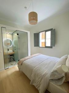 a bedroom with a bed and a walk in shower at La Puebla Rooms in Teror