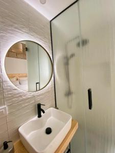 a bathroom with a sink and a mirror at La Puebla Rooms in Teror
