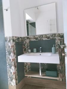 a bathroom with a white sink and a mirror at Villa Simo in Altavilla Milicia
