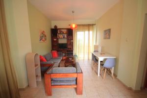 a living room with a couch and a table at Maria's house Alykes in Kritharia