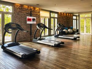 a gym with three treadmills and weights in a room at Trendy Apartment in Puerto Madero in Buenos Aires