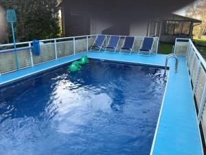 a pool with chairs and a toy in the water at Hidden Farm Escape in the Heart of Kawarthas in Beaverton