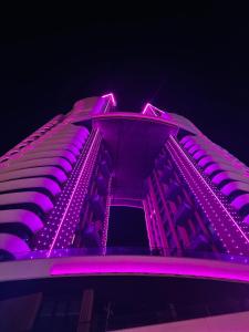 a building with purple lights on top of it at Otel konforunda Lux Residence in Konak