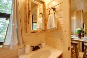 a bathroom in a log cabin with a sink and a mirror at Scenic Deck and Grill Middlebury Center Retreat! in Middlebury Center +20 photos
