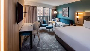 a hotel room with a bed and a desk at Hyatt Regency San Francisco in San Francisco +113 photos