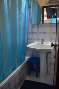 baño con lavabo y cortina de ducha azul en OrlaBela, en Manta Rota