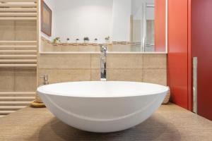 a large white bath tub in a bathroom at Loft Corso Trieste in Bari