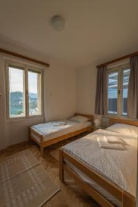 a room with two beds and two windows at Villa Anna in Bled