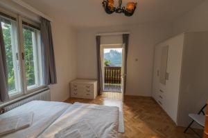 a bedroom with a large bed and a window at Villa Anna in Bled