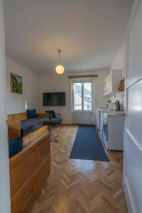 a kitchen and living room with a couch and a table at Villa Anna in Bled