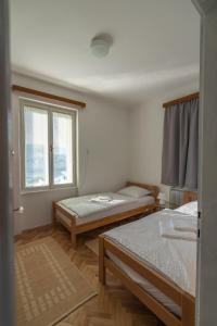 a room with two beds and a window at Villa Anna in Bled