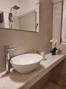 a white bowl sink on a counter in a bathroom at Anthoula Home Paros in Naousa