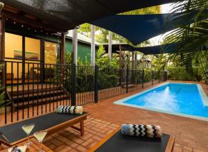 a swimming pool in a backyard with a black fence at Villa within walking distance of cable beach Australia in Cable Beach