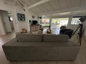 a living room with a couch and a table at Maison bord de mer in Le Gosier