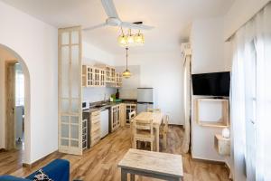 a living room with a table and a kitchen at Dahab One - El Primo VIP apartments in Dahab