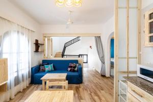 a living room with a blue couch and a table at Dahab One - El Primo VIP apartments in Dahab