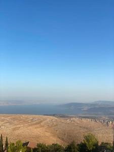 a view of a field and a body of water at מצפה הכינרת in Safed