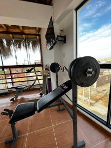 a gym with two tread machines and a window at Gamora Hotel Playa in Los Órganos