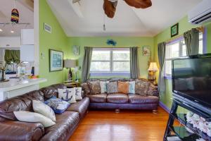 a living room with brown leather couches and a kitchen at Key West Paradise with Private Pool and Ocean View in Cudjoe Key