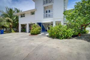 a large white house with a large driveway at Key West Paradise with Private Pool and Ocean View in Cudjoe Key