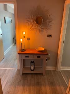 a room with a table with a bowl on it at Corinthian Quay Apartment in Edinburgh