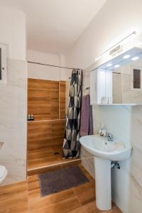 a bathroom with a sink and a shower at Grand Apartment Next to Center 3bd 110sqm in Thessaloniki +43 photos