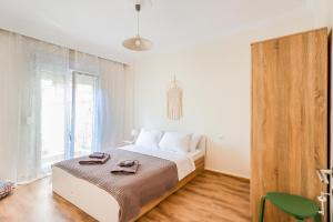 a bedroom with a bed and a large window at Grand Apartment Next to Center 3bd 110sqm in Thessaloniki