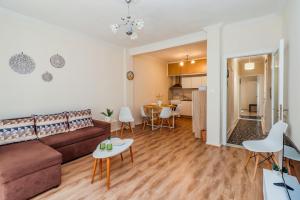 a living room with a couch and a table at Grand Apartment Next to Center 3bd 110sqm in Thessaloniki