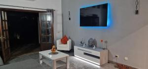 a living room with a couch and a tv on the wall at Casa De Nefertiti in Playa Blanca