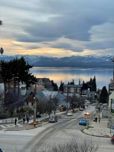 a view of a town with a lake and mountains at Antu Mahuida Apartments in San Carlos de Bariloche