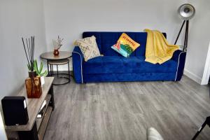 a living room with a blue couch and a table at Seaside Flat, Contractors, Family, Business, Parking in Portslade