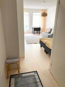 a living room with a bed and a living room with a piano at PEURANIITTY 3 - Modern easygoing apartment in Espoo