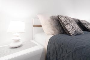 sypialnia z łóżkiem z poduszkami i lampą w obiekcie TATRA Apartments Zakopane w Zakopanem