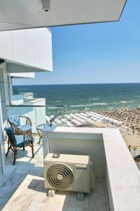 a fan on a balcony overlooking the beach at Unique Sea View Infinity Pool & Spa in Mamaia Nord