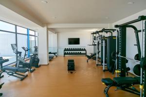 a gym with lots of treadmills and machines at Unique Sea View Infinity Pool & Spa in Mamaia Nord
