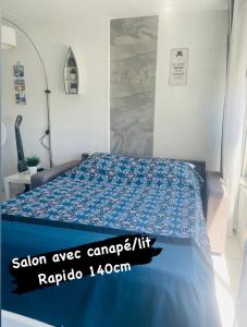 - une chambre avec un lit et une couette bleue dans l'établissement Superbe appartement 6 personnes avec piscine secteur Richelieu, à 400m de la plage et à 650m du centre port, au Cap d'Agde