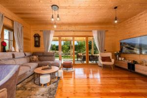 a living room with a couch and a tv at Vila Lipa in Ličko Cerje