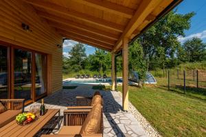 a wooden pavilion with a table and chairs on a patio at Vila Lipa in Ličko Cerje