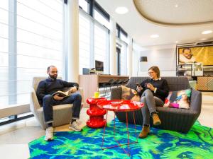 a group of people sitting in chairs in a room at Aparthotel Adagio Köln City in Cologne