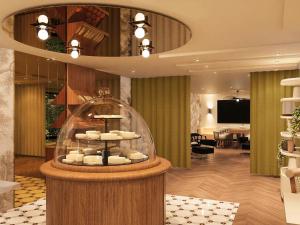 a lobby with a display case with bowls in it at Mercure Paris Ouest Saint Germain in Saint-Germain-en-Laye