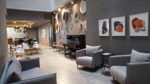 a living room with couches and chairs and a fireplace at Best Western Santorin in Ciudad Victoria