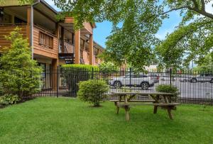a picnic table in a yard in front of a building at SureStay Plus by Best Western Woodbury Inn in Woodbury