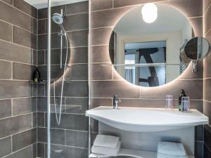 a bathroom with a sink and a mirror at Aparthotel Adagio Glasgow Central in Glasgow