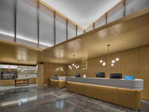 a lobby with a reception desk and chairs at Hilton Garden Inn Beijing Haidian Daoxiang Lake in Beijing