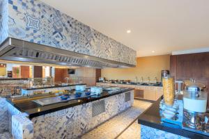 a large kitchen with a sink and a counter at Courtyard by Marriott Mazatlan Beach Resort in Mazatlán